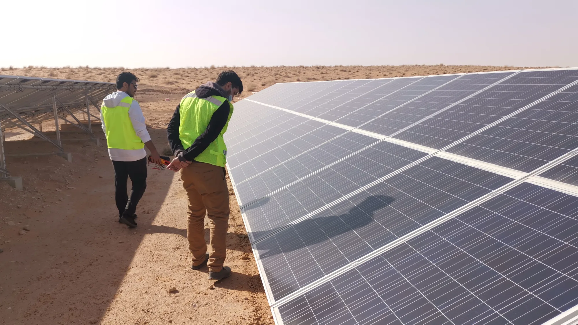 Future Earth engineers commissioning a ground-mounted solar array
